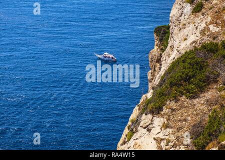 Alghero, Sardinia / Italy - 2018/08/11: Panoramic view of the Gulf of Alghero with cliffs of Cape Cappo Caccia over the Neptune`s Grotto Stock Photo